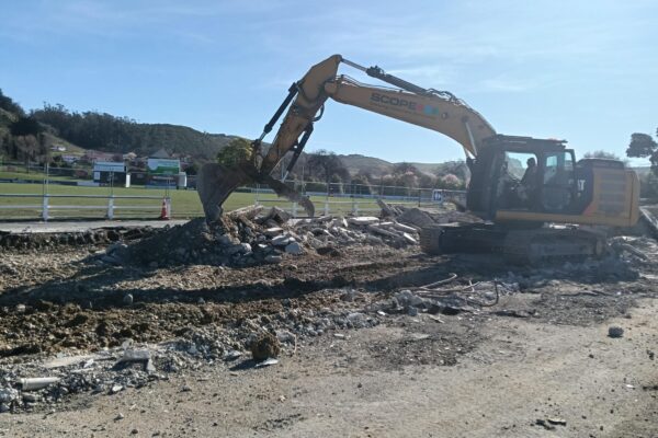 image of Scope Group excavator demolishing and deconstructing rugby grandstand in North Otago, New Zealand